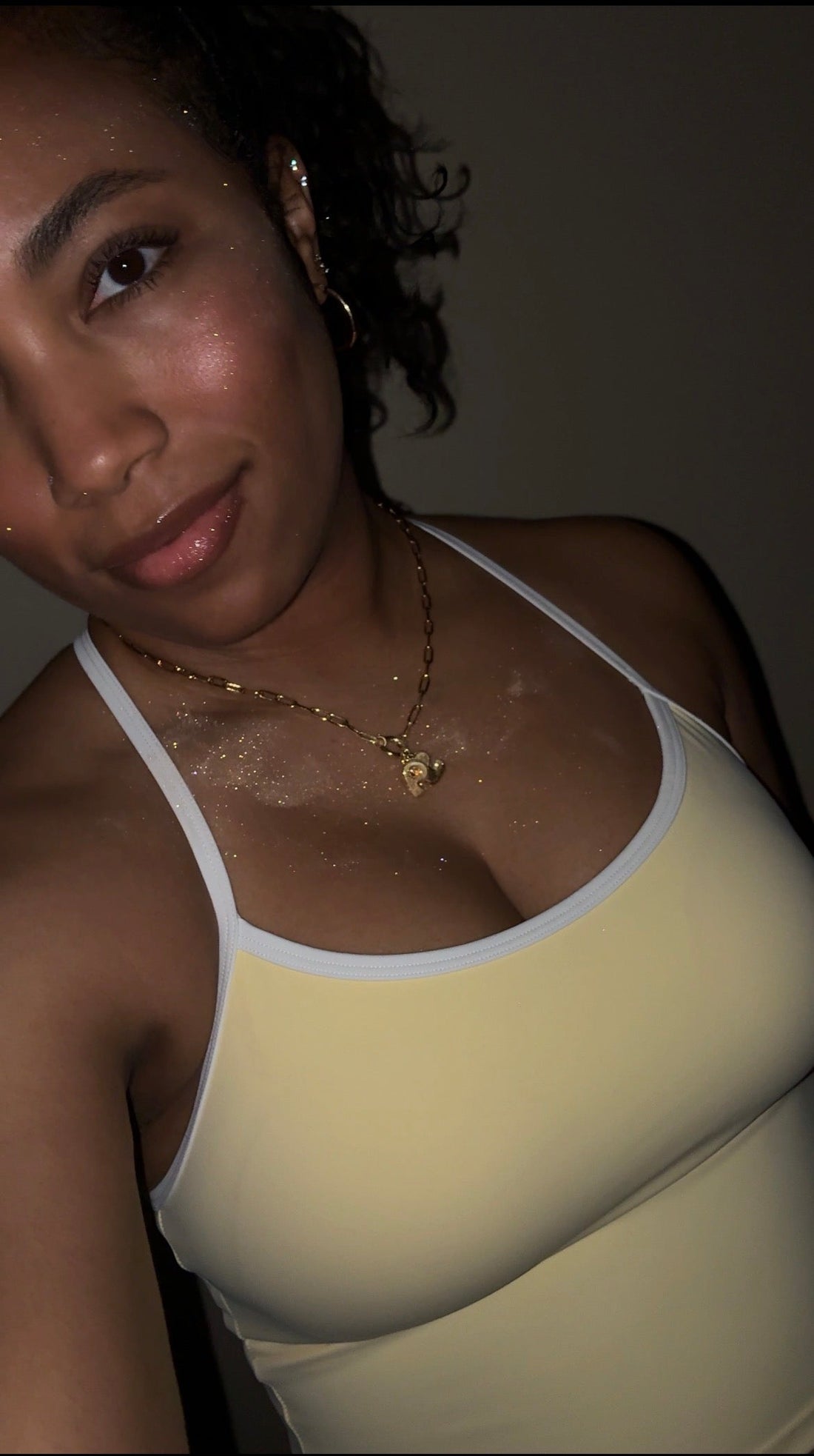 Female in frame, wearing Fairy Dust in shade Golden Hour on chest and face. 