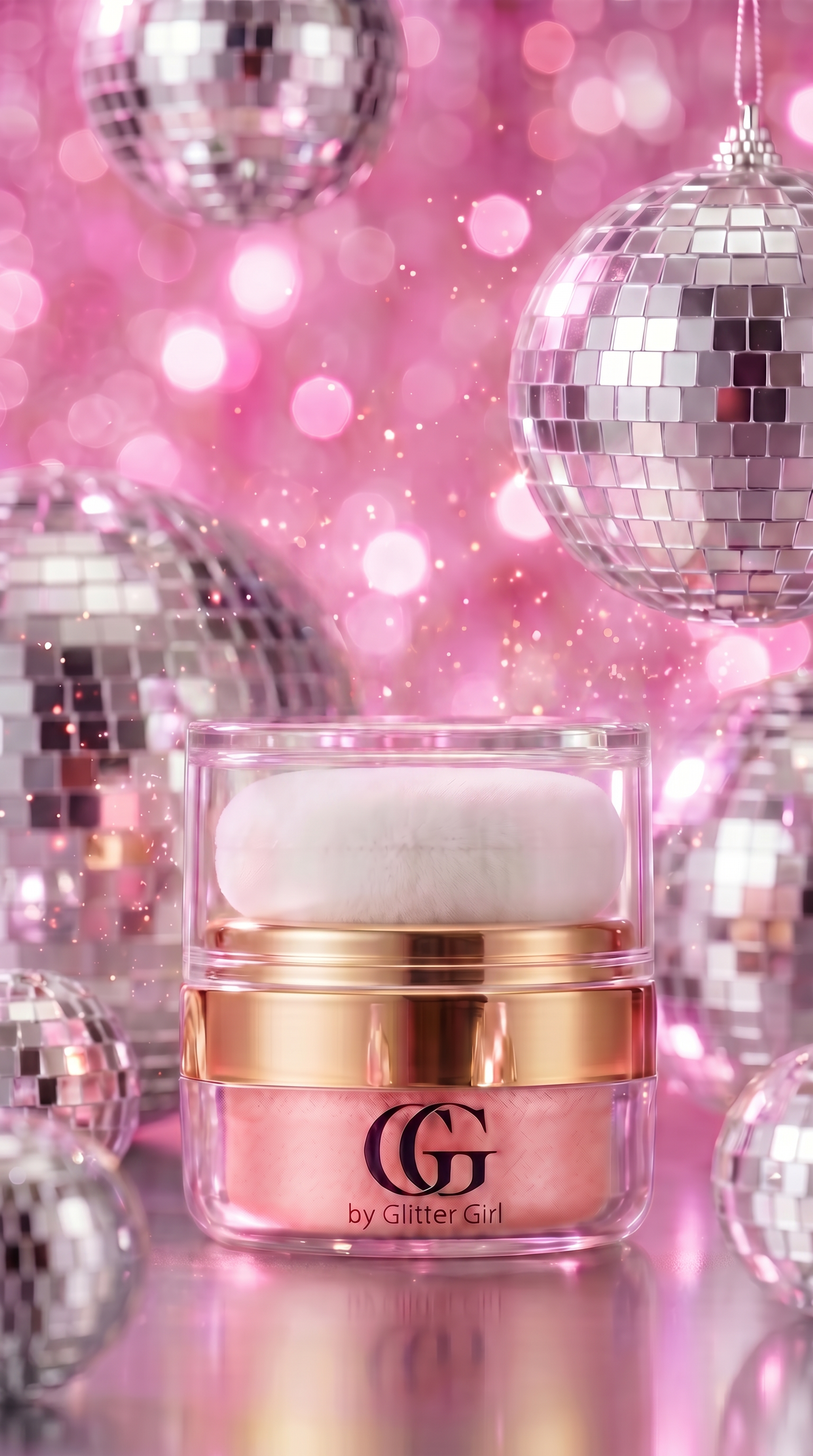  cosmetic jar with a white puff applicator, featuring a gold band and a pink shade visible through the clear container. The jar is set against a festive background of pink bokeh lights and silver disco ball ornaments.